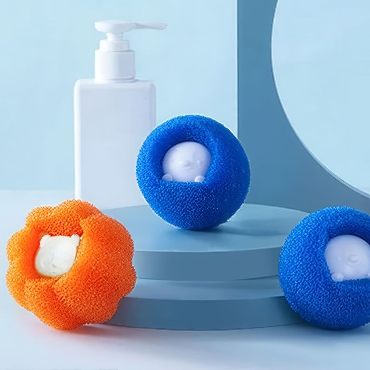 Blue and orange pet hair remover balls on a laundry shelf